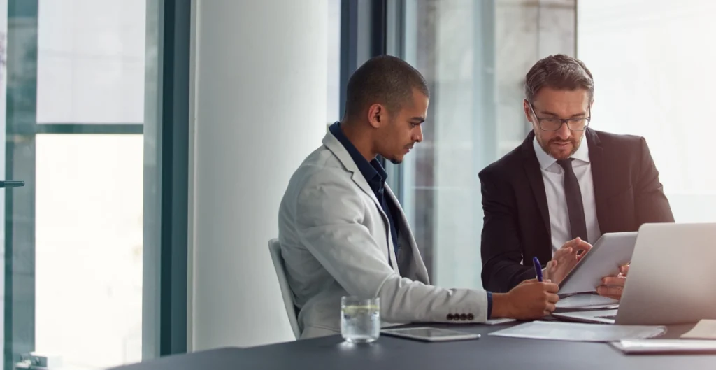 Featured Image For On Demand Webinars with a to employees collaborating at a desk.